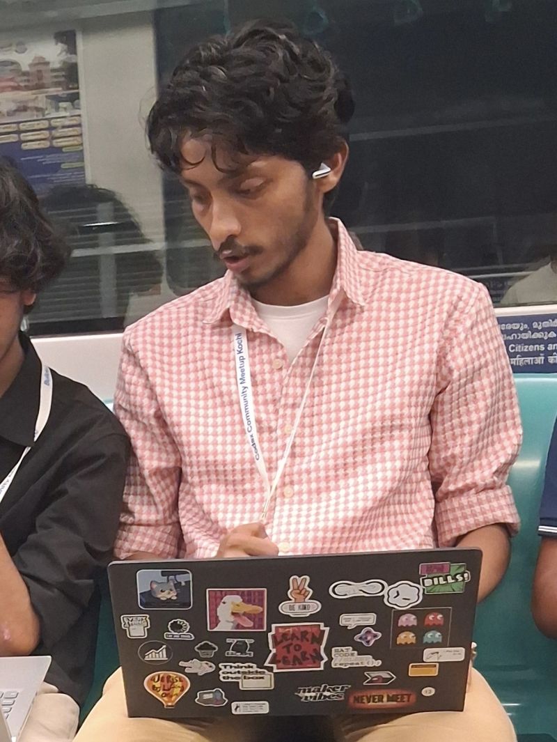 Shayen Thomas building Veyro on a laptop inside a moving Kochi Metro train during Codex Nightline